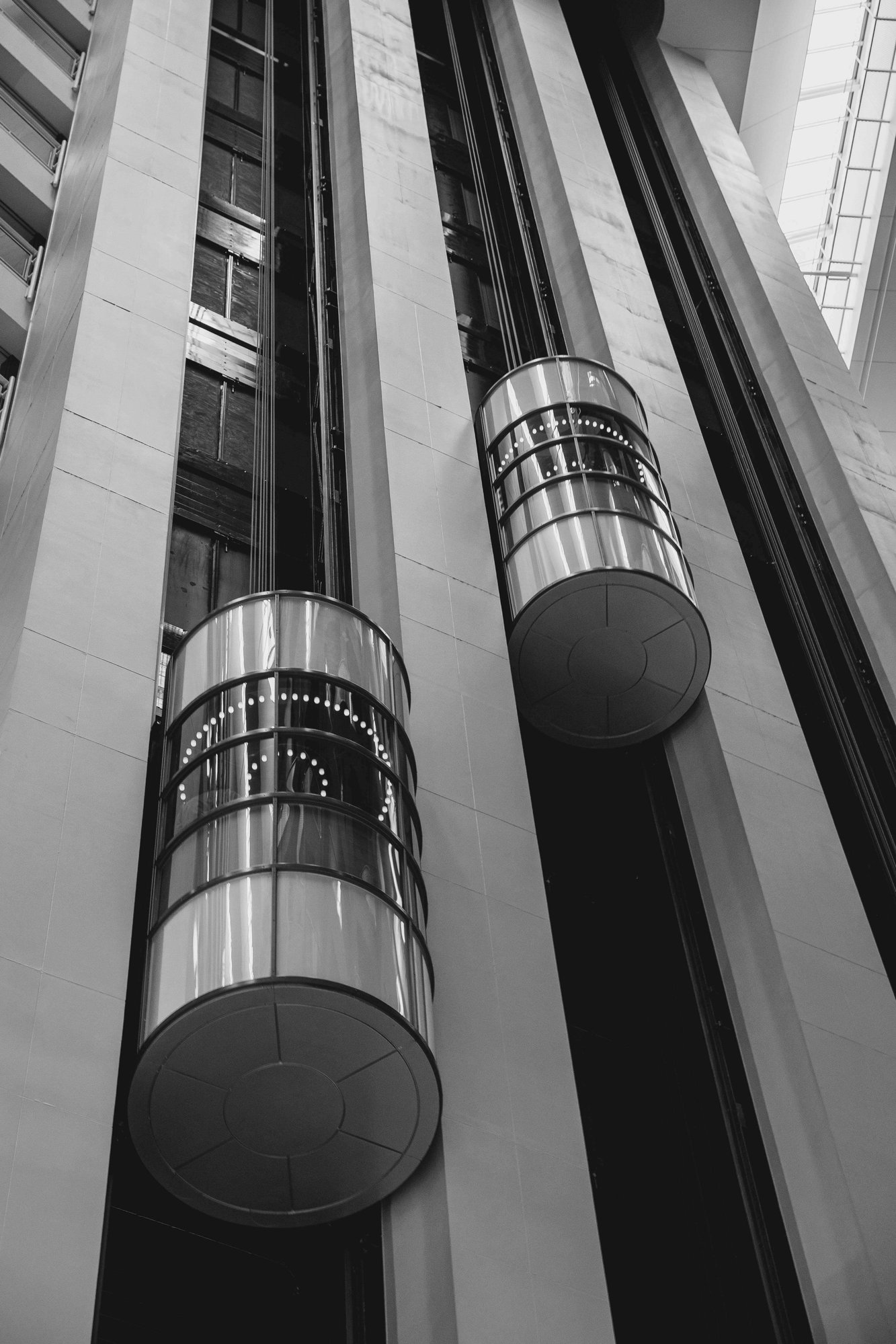 Futuristic glass elevators ascending in a high-rise building, symbolising progress and upward momentum.